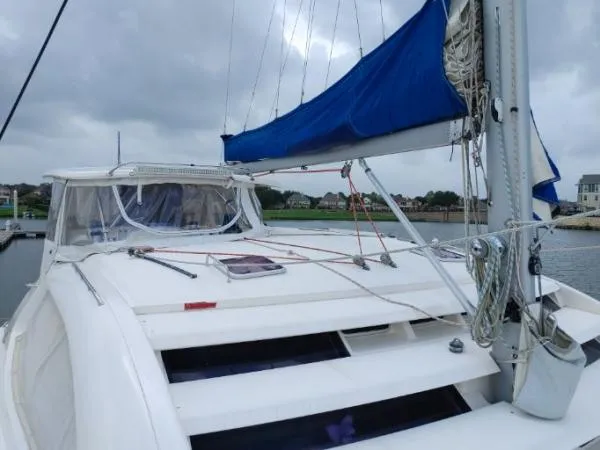 Titan 46 Yacht Photos Pics Sailing yacht Leopard 46, 2011 model, docked with blue sail cover, overcast sky.