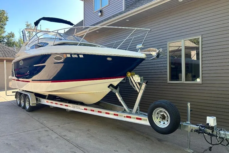  Yacht Photos Pics 2017 Regal 30 Express boat on trailer beside house.