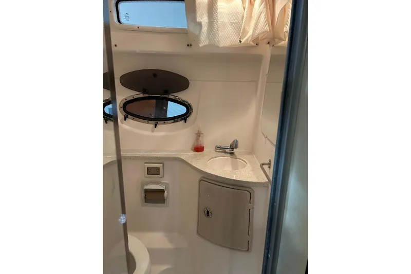  Yacht Photos Pics 2017 Regal 30 Express boat bathroom with sink, window, and storage cabinet.