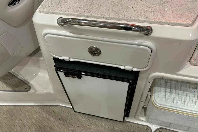  Yacht Photos Pics 2017 Regal 30 Express boat interior with compact refrigerator and storage compartment.