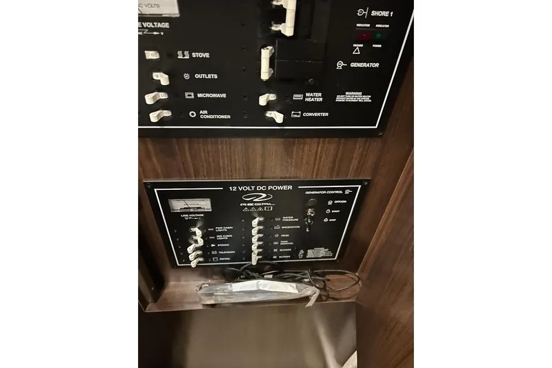  Yacht Photos Pics Control panel of a 2017 Regal 30 Express boat, featuring power switches and indicators.