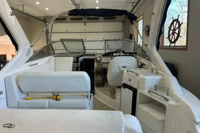  Yacht Photos Pics 2017 Regal 30 Express boat interior with white seating and helm in a garage.