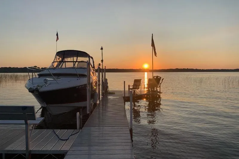  Yacht Photos Pics 2017 Regal 30 Express boat docked at sunset on a serene lake.