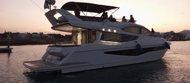 Sadeen Yacht Photos Pics 2016 Galeon 550 Fly yacht at sunset, featuring sleek design and spacious flybridge.