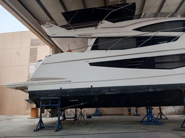 Sadeen Yacht Photos Pics 2016 Galeon 550 Fly yacht in dry dock, side view, under maintenance.