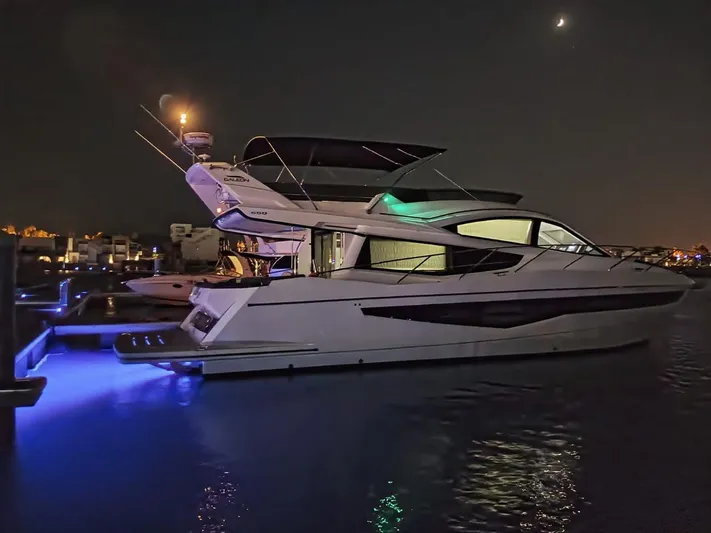 Sadeen Yacht Photos Pics 2016 Galeon 550 Fly yacht illuminated at night, docked with moonlit sky.
