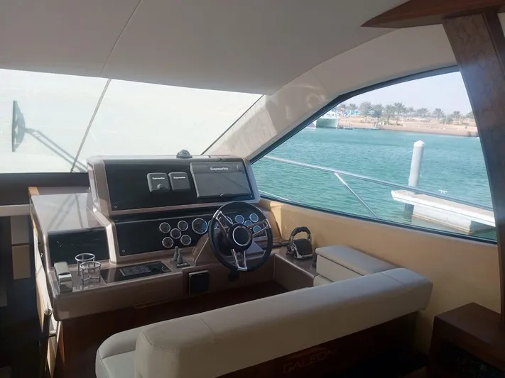 Sadeen Yacht Photos Pics Interior helm of 2016 Galeon 550 Fly yacht with modern controls and sea view.
