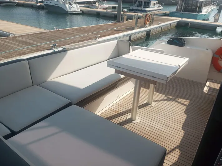 Sadeen Yacht Photos Pics Outdoor seating area on 2016 Galeon 550 Fly yacht at marina.