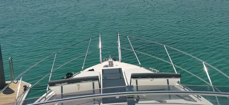 Sadeen Yacht Photos Pics Bow view of 2016 Galeon 550 Fly yacht on calm water.