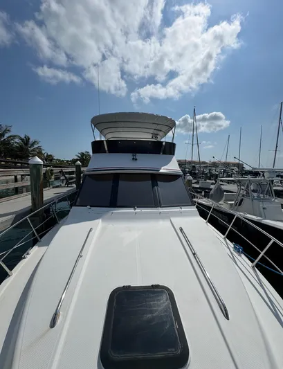  Yacht Photos Pics 1994 President 445 Sundeck yacht docked under a partly cloudy sky.