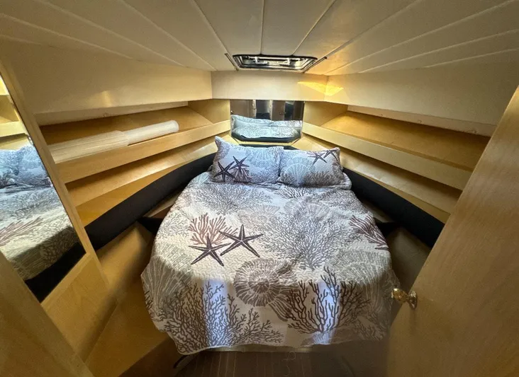  Yacht Photos Pics Cozy cabin interior of 1994 President 445 Sundeck yacht with starfish-themed bedding.