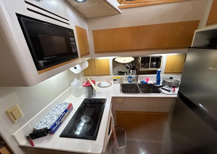  Yacht Photos Pics Compact kitchen in a 1994 President 445 Sundeck yacht with modern appliances.