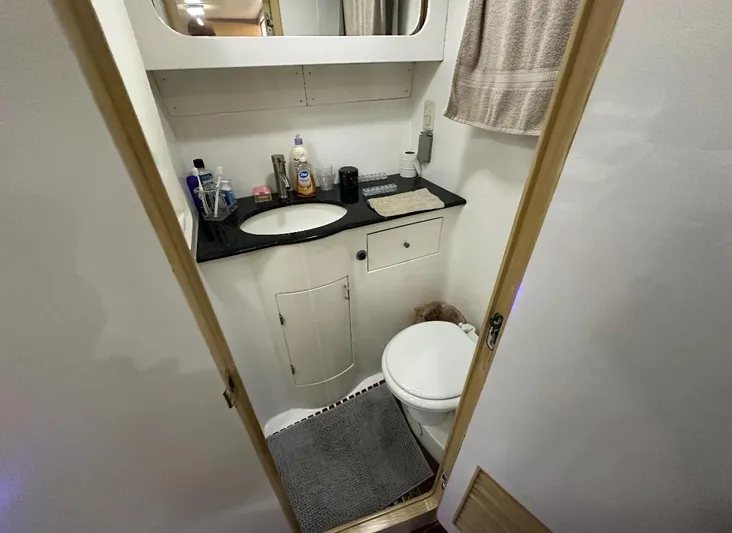  Yacht Photos Pics Bathroom interior of 1994 President 445 Sundeck yacht, featuring sink and toilet.