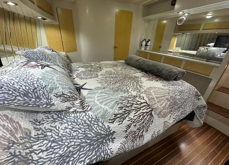  Yacht Photos Pics Luxurious bedroom interior of 1994 President 445 Sundeck yacht with nautical-themed bedding.