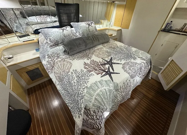  Yacht Photos Pics Luxurious bedroom interior of 1994 President 445 Sundeck yacht with nautical-themed bedding.