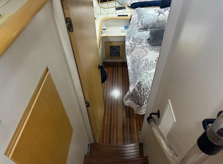  Yacht Photos Pics Interior view of 1994 President 445 Sundeck yacht, featuring wooden flooring and cozy cabin space.