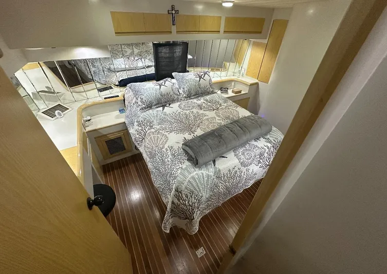  Yacht Photos Pics Luxurious bedroom interior of a 1994 President 445 Sundeck yacht with elegant bedding.