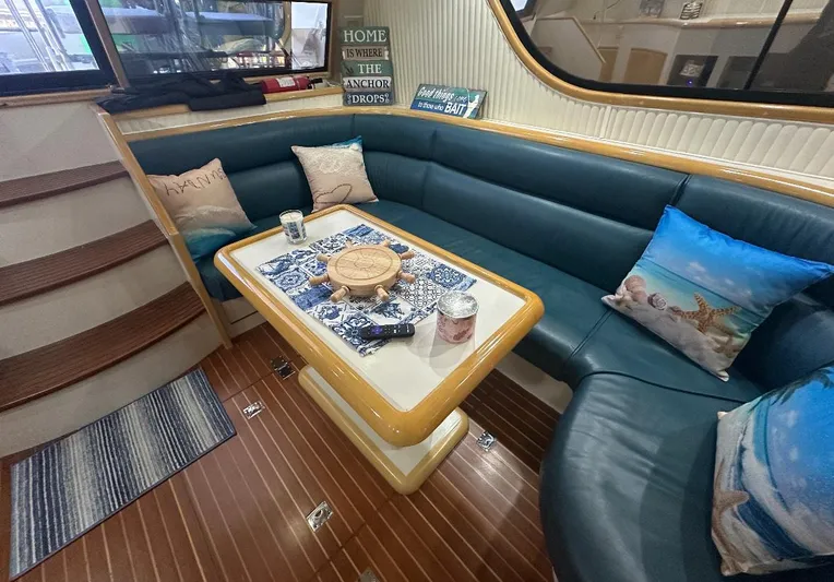  Yacht Photos Pics Cozy interior of 1994 President 445 Sundeck yacht with blue seating and decorative pillows.