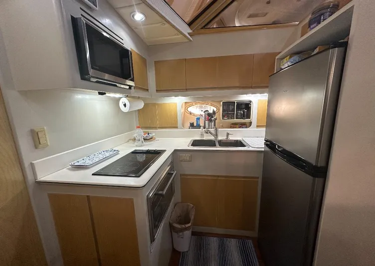  Yacht Photos Pics Compact kitchen in a 1994 President 445 Sundeck yacht with modern appliances.