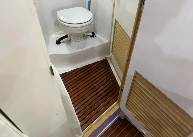  Yacht Photos Pics 1994 President 445 Sundeck yacht bathroom with wooden flooring and compact toilet.