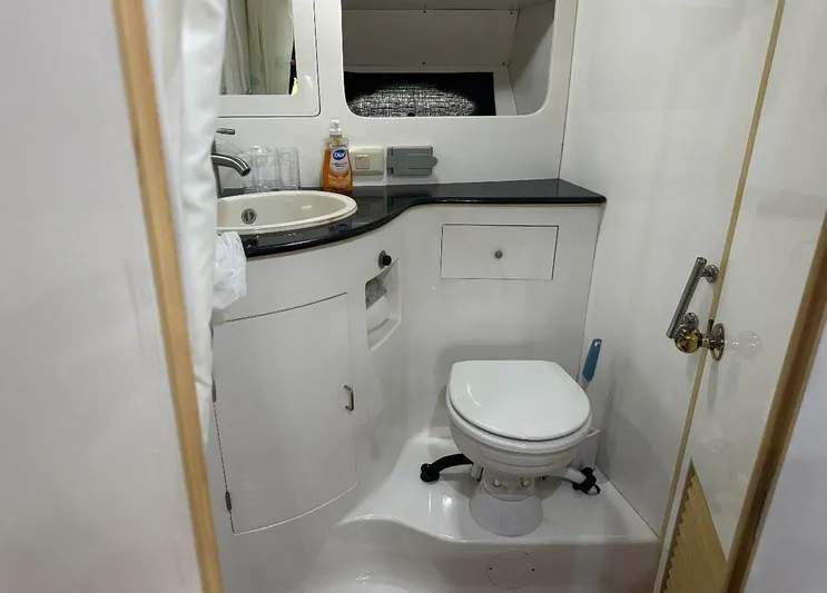  Yacht Photos Pics Bathroom interior of 1994 President 445 Sundeck yacht, featuring sink and toilet.