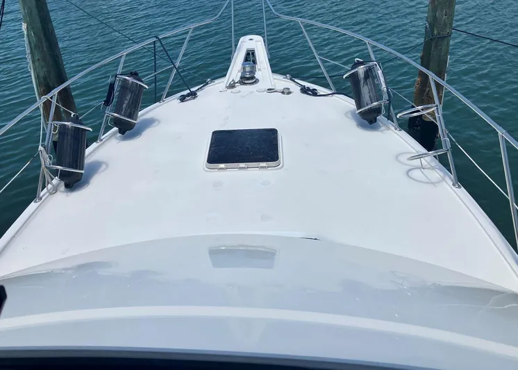 New Moon Yacht Photos Pics Bow view of 1996 Hatteras 42 CPMY yacht docked on calm water.