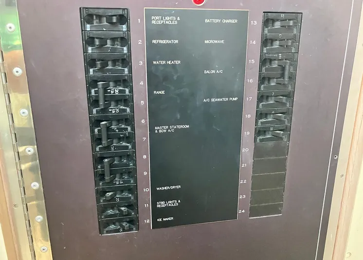 New Moon Yacht Photos Pics Electrical panel of a 1996 Hatteras 42 CPMY yacht with labeled circuit breakers.