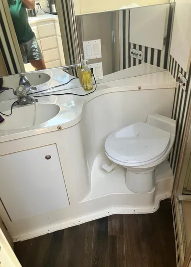 New Moon Yacht Photos Pics Bathroom interior of 1996 Hatteras 42 CPMY yacht with sink and toilet.