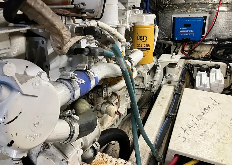 New Moon Yacht Photos Pics Engine room of 1996 Hatteras 42 CPMY with CAT filter and labeled components.