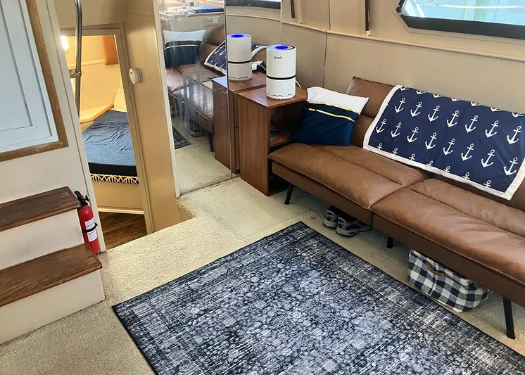 New Moon Yacht Photos Pics Interior of 1996 Hatteras 42 CPMY yacht with cozy seating and nautical decor.