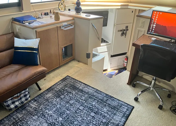 New Moon Yacht Photos Pics Interior of 1996 Hatteras 42 CPMY yacht with cozy seating and workspace.