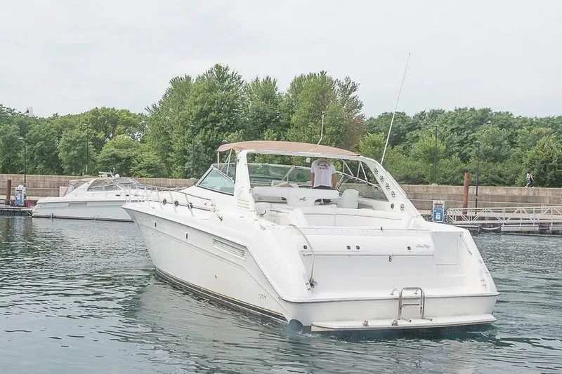  Yacht Photos Pics 1998 Sea Ray 500 Sundancer yacht docked in a serene marina setting.