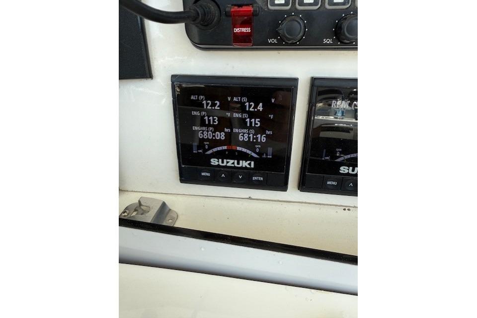 Control panel of a 1999 Venture 34 Open boat with Suzuki engine displays.