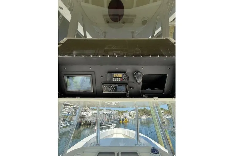  Yacht Photos Pics 1999 Venture 34 Open boat dashboard with navigation equipment and marina view.