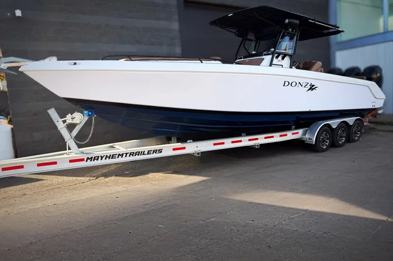  Yacht Photos Pics 2006 Donzi 35 ZF Cuddy boat on Mayhem Trailers, parked outdoors.