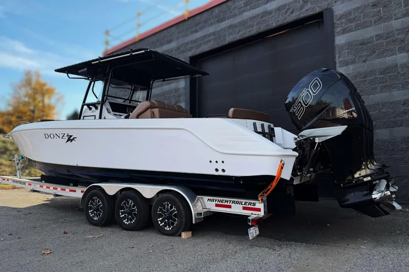  Yacht Photos Pics 2006 Donzi 35 ZF Cuddy boat on trailer, featuring powerful outboard engines.