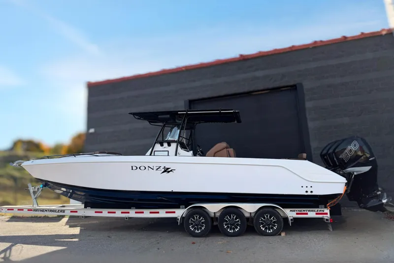  Yacht Photos Pics 2006 Donzi 35 ZF Cuddy boat on trailer, parked outdoors.