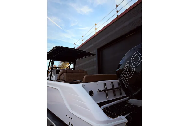  Yacht Photos Pics 2006 Donzi 35 ZF Cuddy boat with powerful engine, docked near a building.