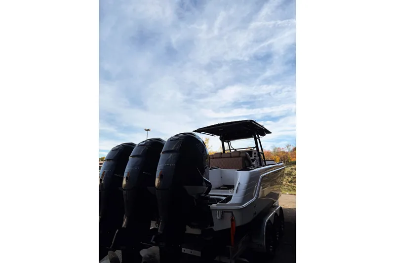  Yacht Photos Pics 2006 Donzi 35 ZF Cuddy boat with triple outboard engines under a cloudy sky.
