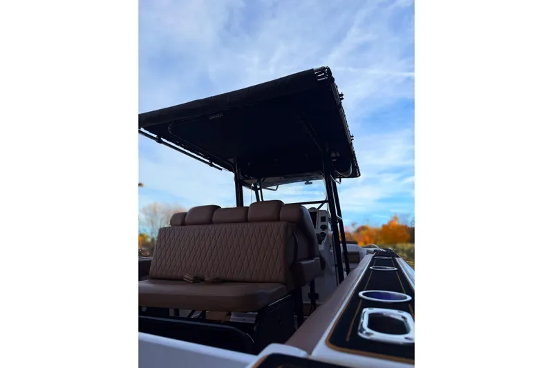  Yacht Photos Pics 2006 Donzi 35 ZF Cuddy boat with brown seating and canopy, under a clear sky.
