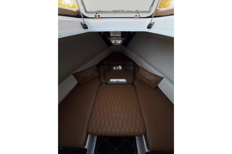  Yacht Photos Pics 2006 Donzi 35 ZF Cuddy cabin interior with brown cushions and pillows.