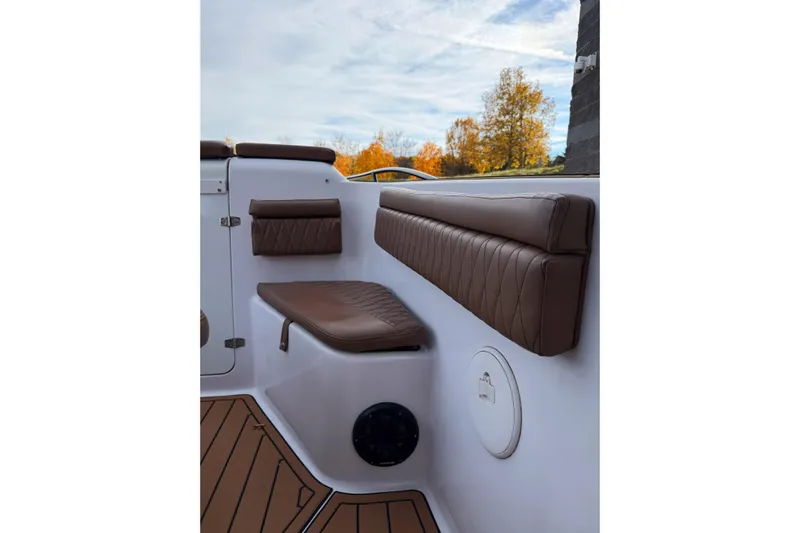  Yacht Photos Pics 2006 Donzi 35 ZF Cuddy interior with brown cushioned seating and autumn backdrop.