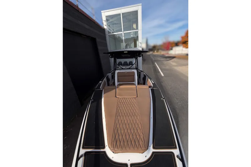  Yacht Photos Pics 2006 Donzi 35 ZF Cuddy boat with sleek design and tan upholstery, docked on a sunny day.