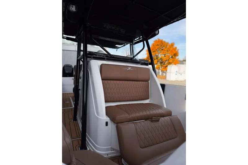  Yacht Photos Pics 2006 Donzi 35 ZF Cuddy boat interior with brown leather seating and sleek design.