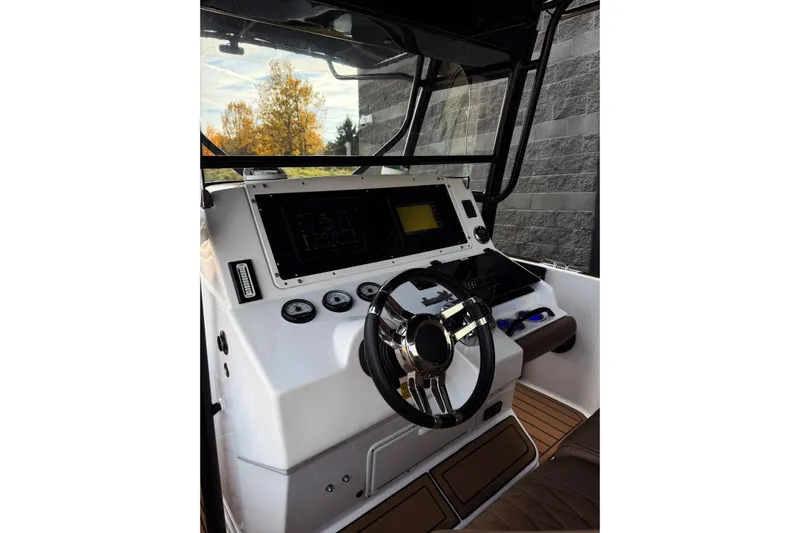  Yacht Photos Pics 2006 Donzi 35 ZF Cuddy boat helm with steering wheel and navigation controls.