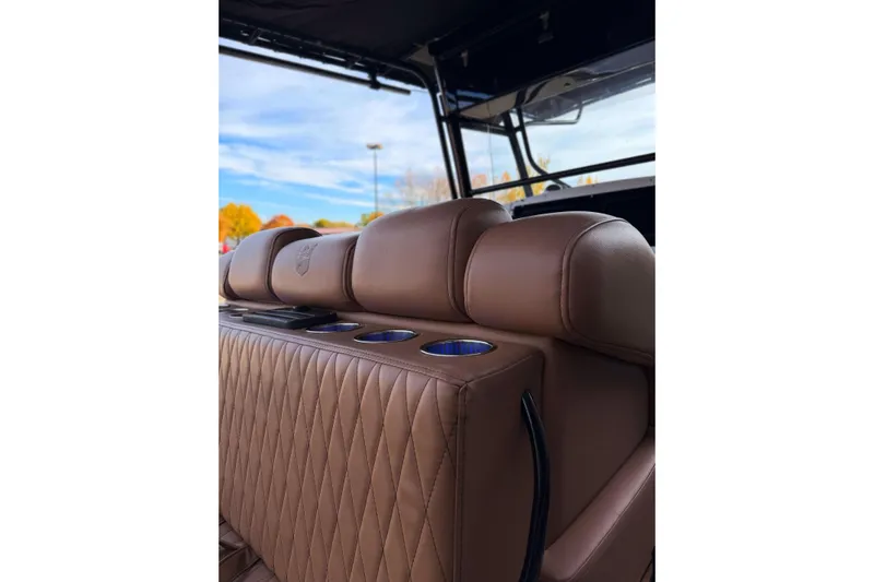  Yacht Photos Pics Luxurious brown leather seating on 2006 Donzi 35 ZF Cuddy boat, featuring cup holders.