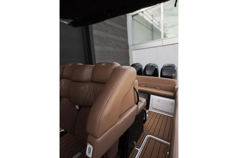  Yacht Photos Pics 2006 Donzi 35 ZF Cuddy boat interior with tan leather seating and multiple outboard engines.