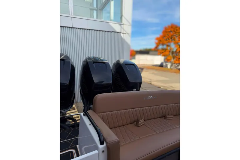  Yacht Photos Pics 2006 Donzi 35 ZF Cuddy boat with triple outboard engines and brown seating.