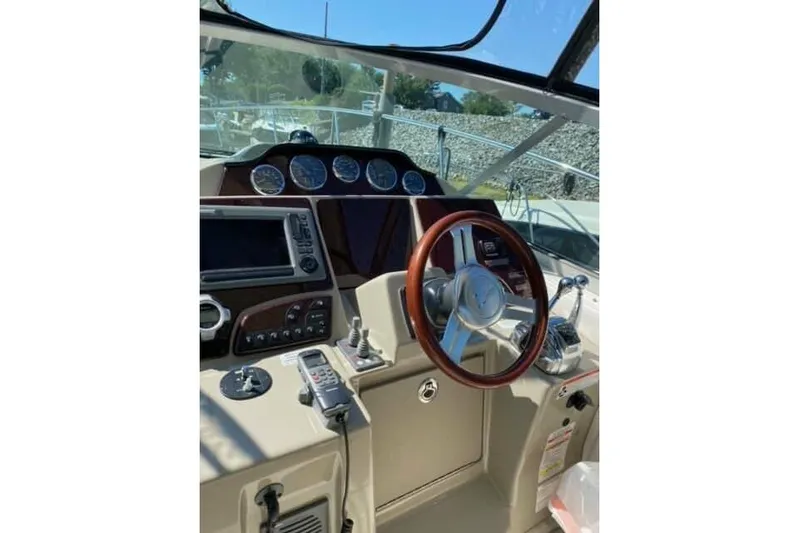  Yacht Photos Pics 2012 Sea Ray 350 Sundancer helm with gauges, steering wheel, and navigation equipment.