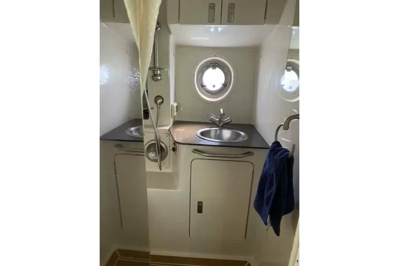  Yacht Photos Pics Bathroom interior of 2012 Sea Ray 350 Sundancer yacht with sink and porthole window.